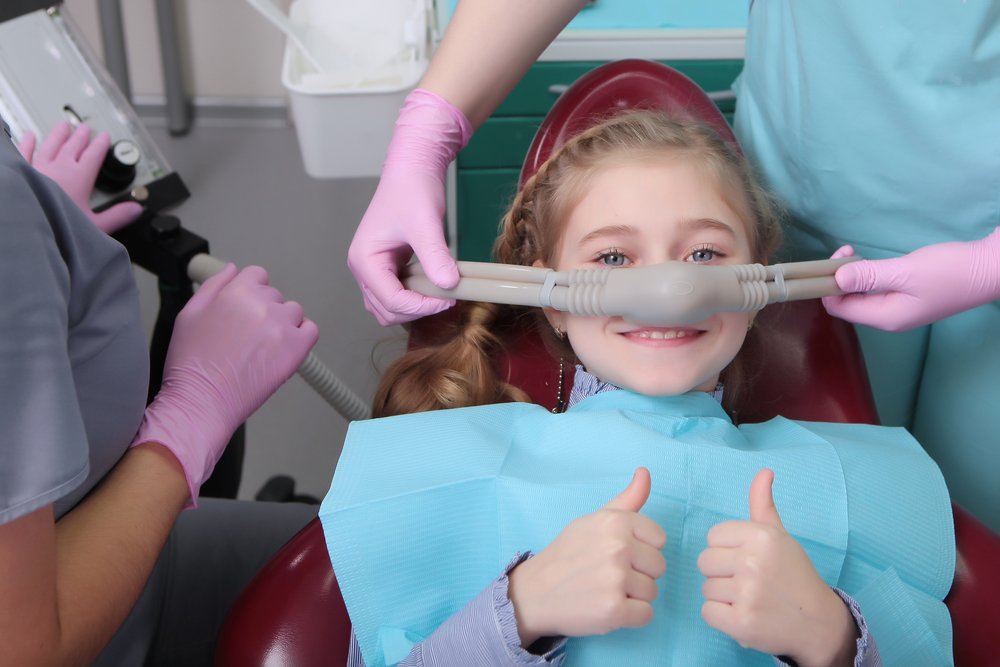 A Little Girl Is Comfortable To Treat Her Teeth Under