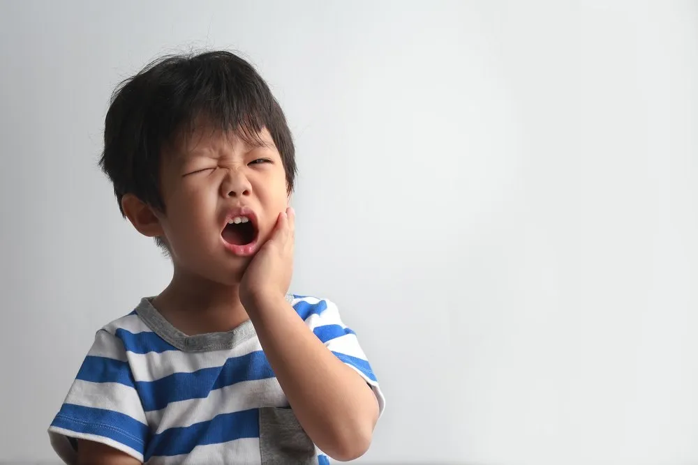 Little Asian Boy Suffering From Toothache