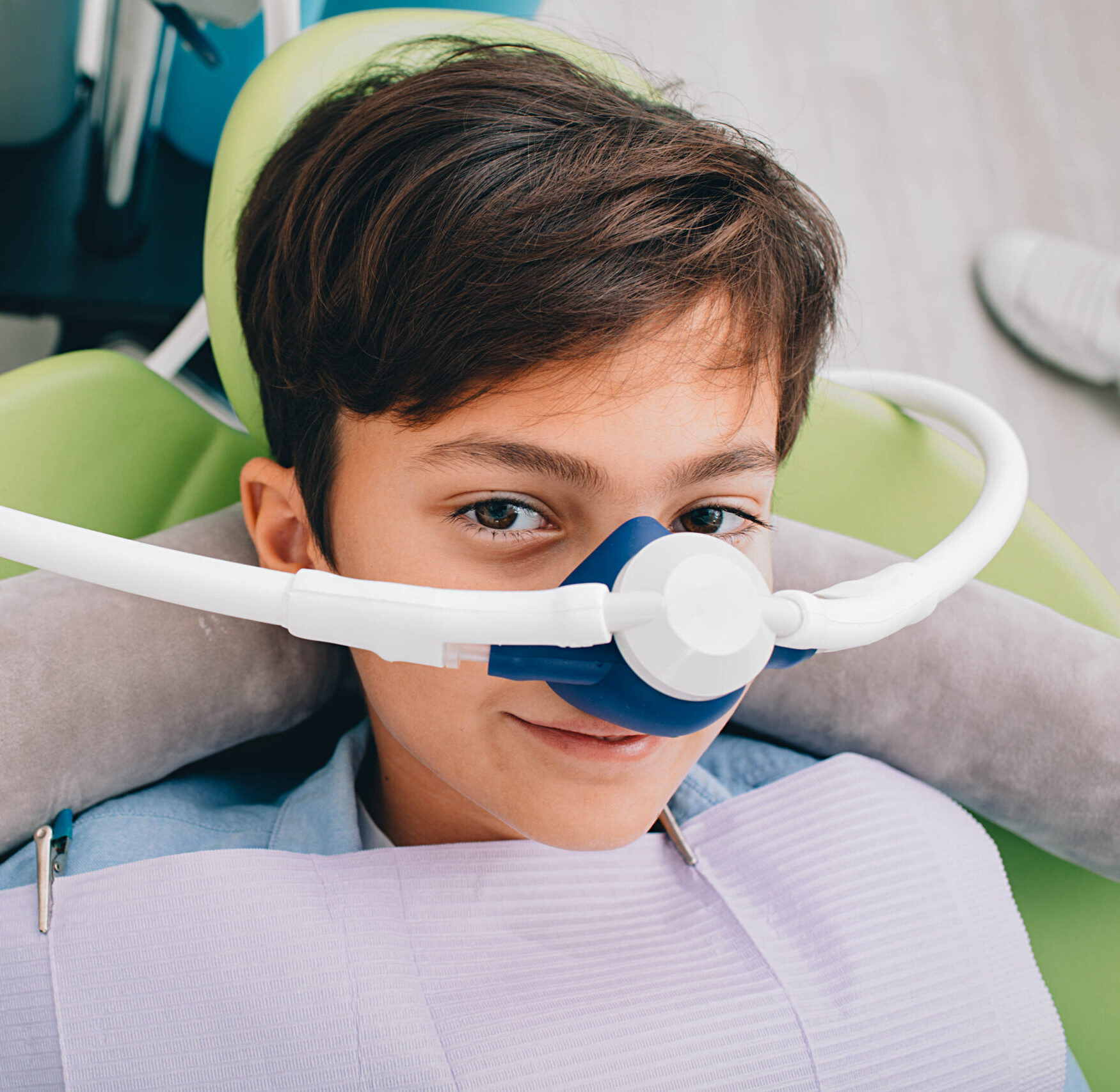 Little boy getting Inhalation Sedation while teeth treatment at dental clinic. Teeth treatment child