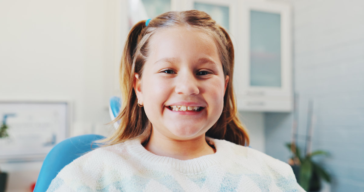 Happy girl, portrait and patient with teeth for dental hygiene, checkup or appointment at clinic. Child, kid or smile with mouth for medical orthodontist, tooth surgery or oral and gum healthcare.