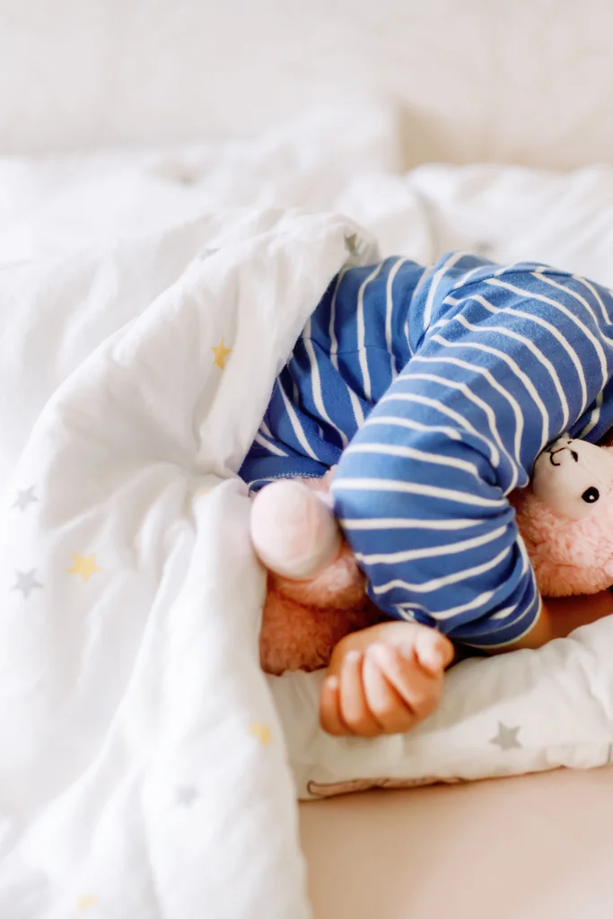 Toddler sleeping in bed with mouth open