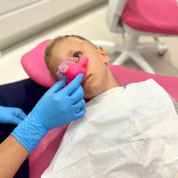 Sedation with nitrous oxide to a child. in a dental clinic